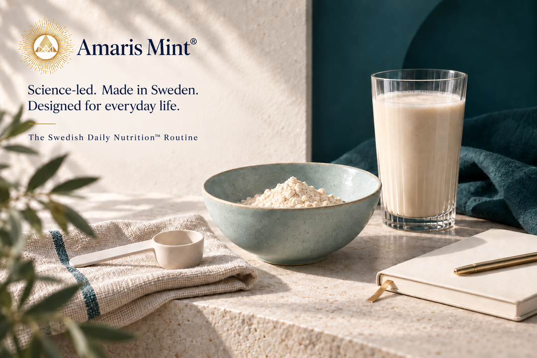 Amaris Mint® gold emblem and wordmark with a bowl of protein powder, a glass and notebook on ivory stone, beside deep teal fabric.