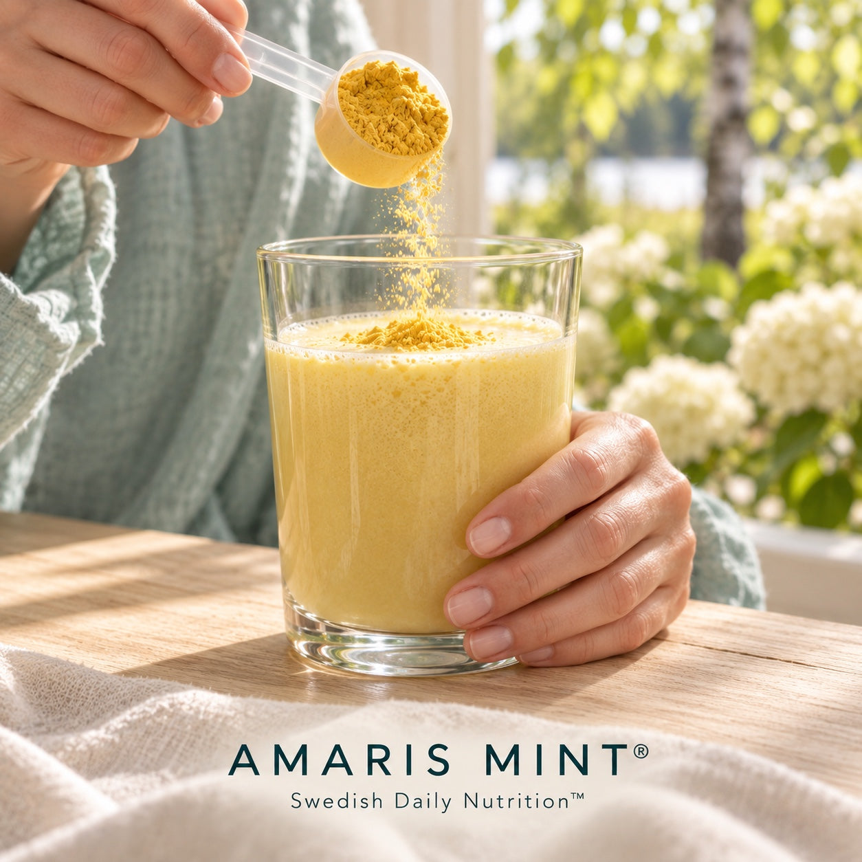 Protein powder being added to a prepared Amaris Mint daily nutrition shake
