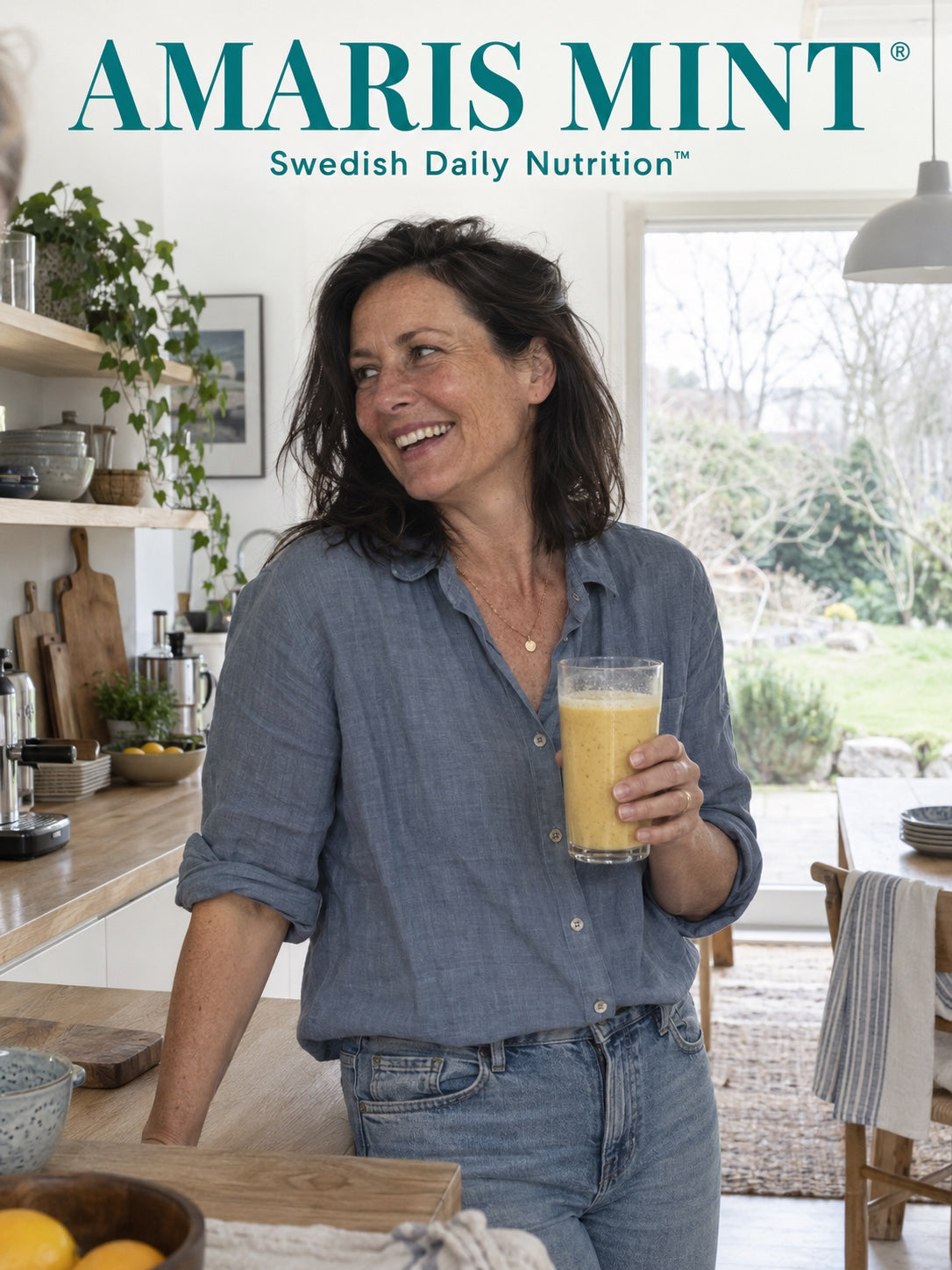 Woman holding an Amaris Mint daily nutrition shake in a relaxed kitchen setting