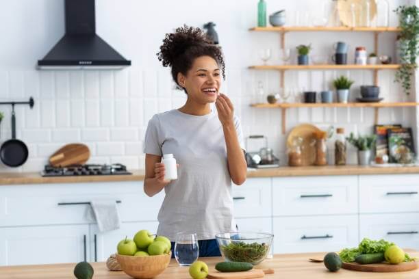 Woman enjoying Amaris Mint® anti-inflammatory protein shake in kitchen
